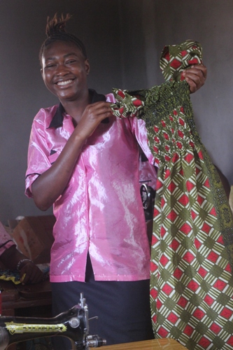 tailoring trainee shows dress she made
