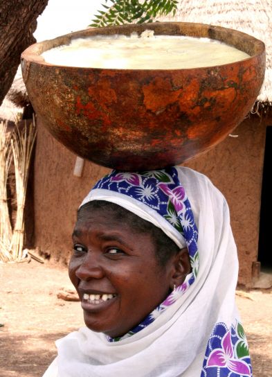 Woman of Kanfiahiyili shea processing group is holding a calabash full of shea butter
