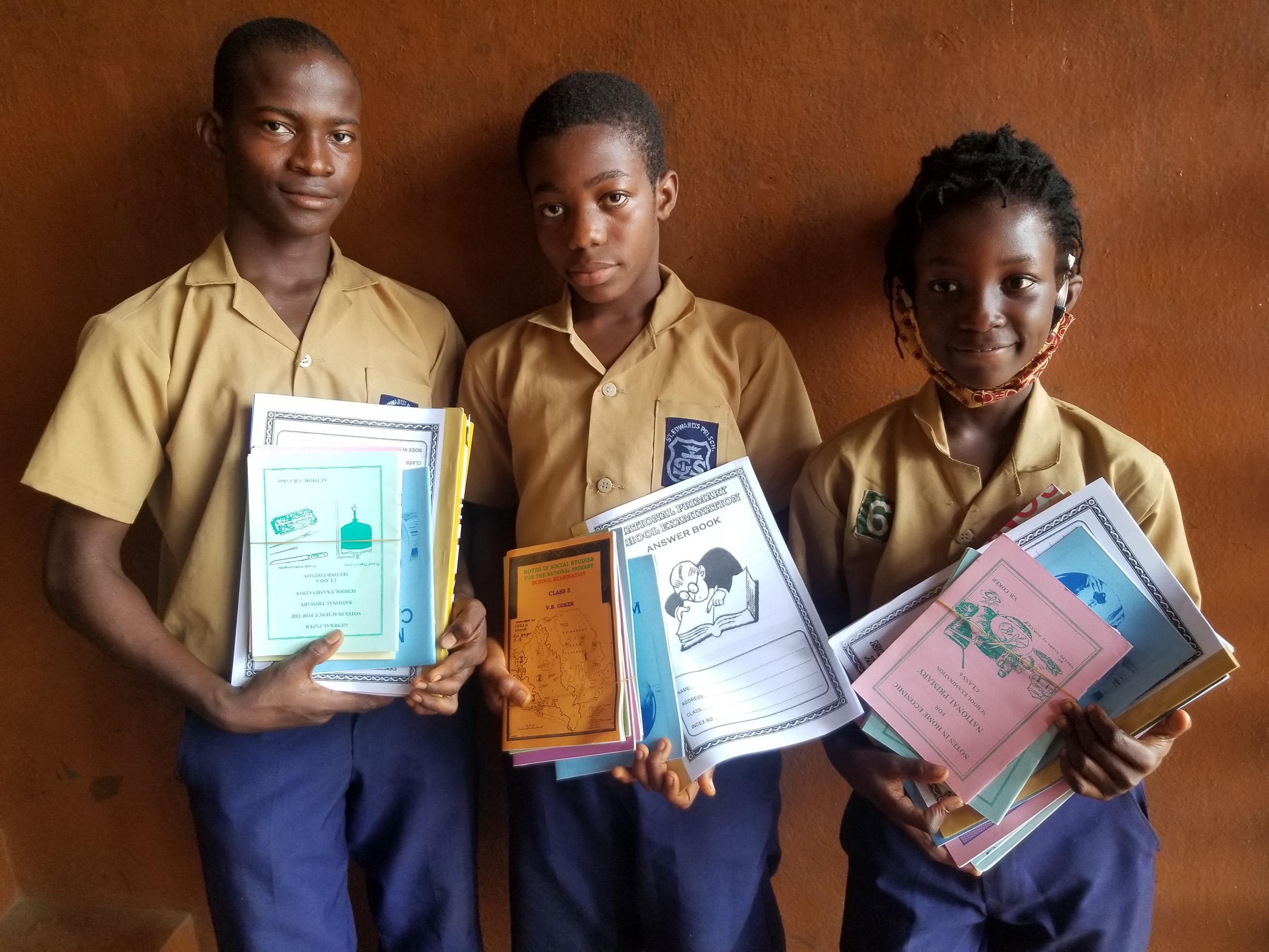 Three Brothers Thankful for School Textbooks