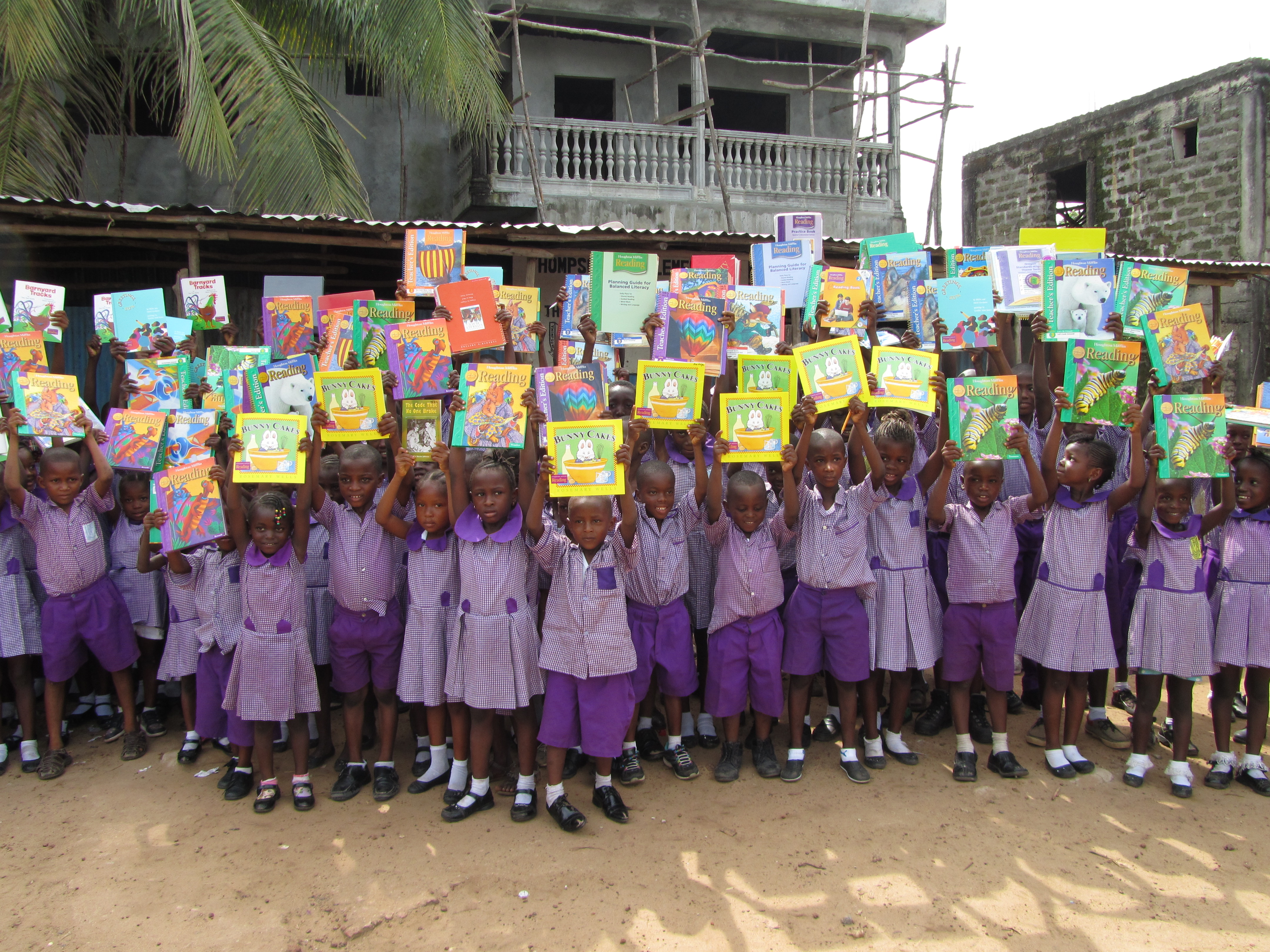Students holding up books 
