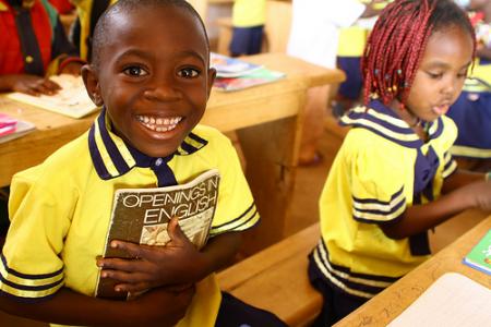 african boy holing book school africa