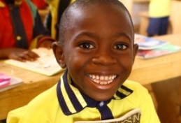 boy in africa holding a book