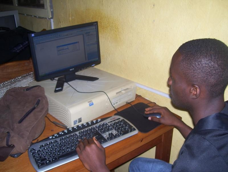 (c) Develop Africa. A young adult operating one of the computers at the Develop Africa Sieraa Leone computer lab.