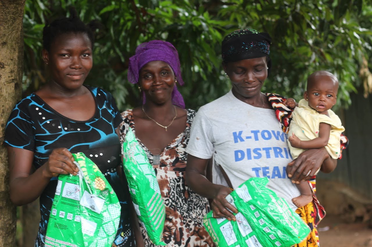 (c) Develop Africa. Mothers showing off their newly acquired mosquito net