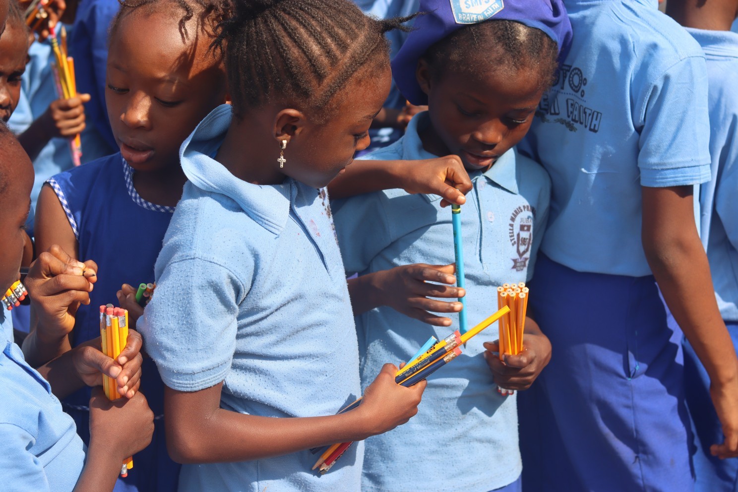 Pupils with pencils provided to them by Develop Africa.