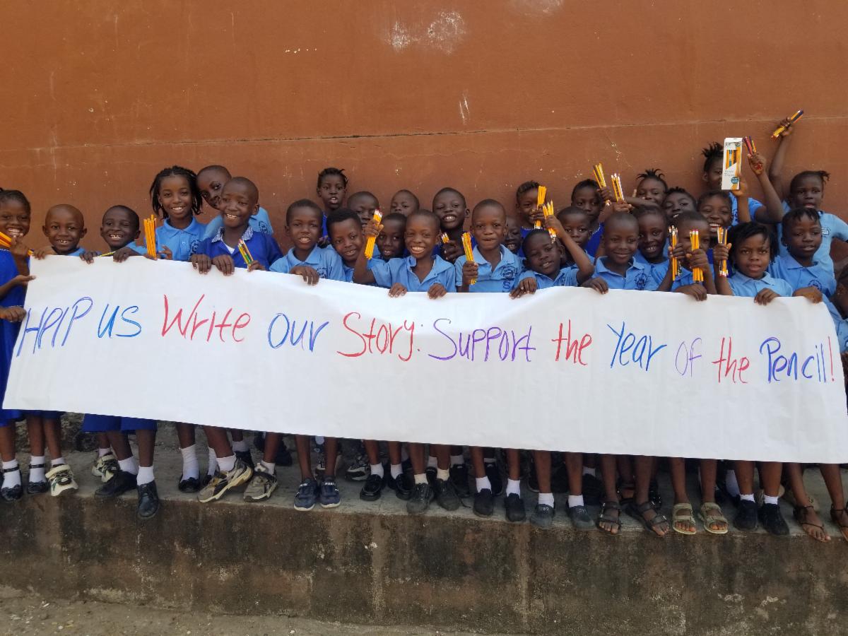 Year of the pencil banner being held by kids