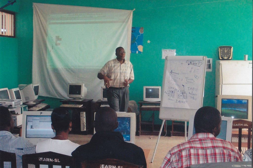 Sylvester in front of the youths teaching them.