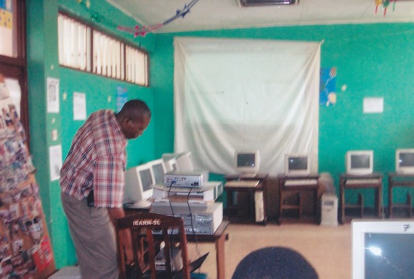 Sylvester adjusting the projector on the stack of books