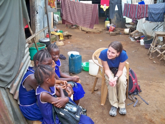 a-lady-sitting-on-a-chair-and-talking-to-kids-in-school-uniform