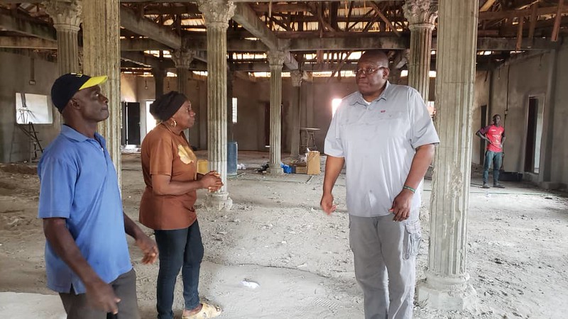 aminata giving sylvester a tour of the calabah town project site - 2025