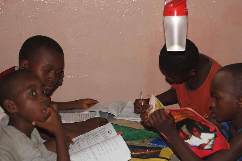 Children studying with solar lamps in Kamawornie