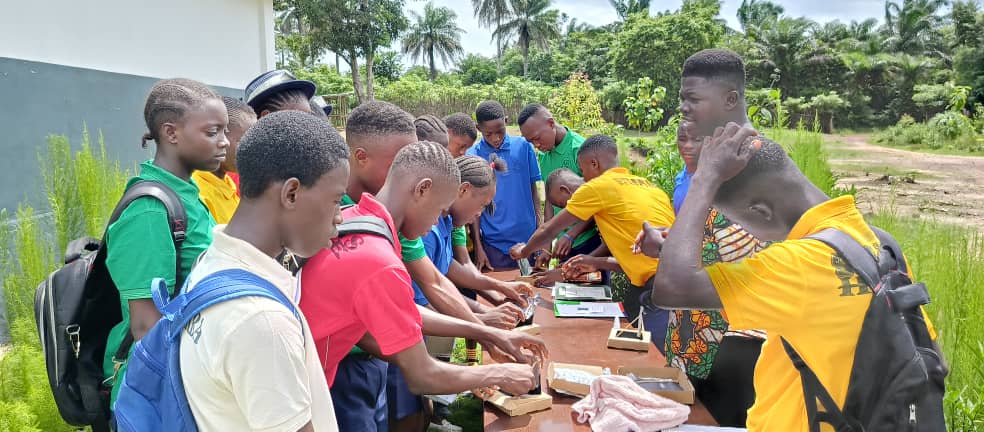 Teacher demonstrating a science practical to students
