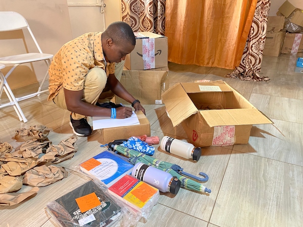 Johanese taking stock of the care package sent to Develop africa for beneficiaries