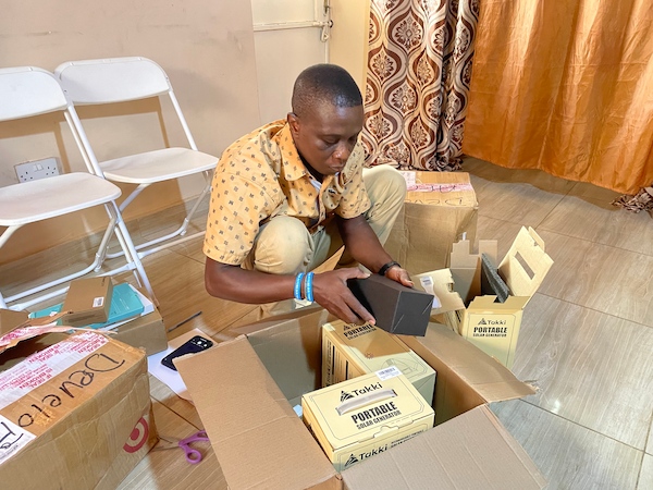 Staff at Develop Africa Sierra Leone unpacking solar packs