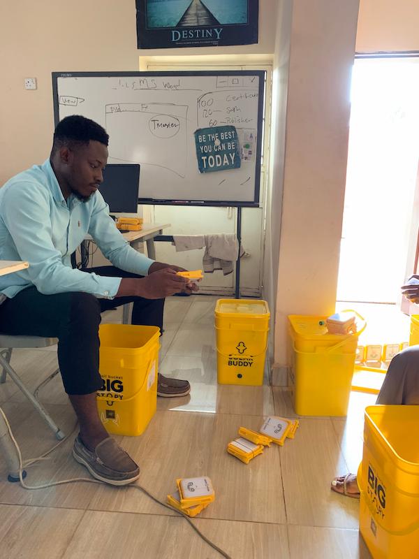Joseph, Develop Africa Staff Testing The Solar Buddy Lamp