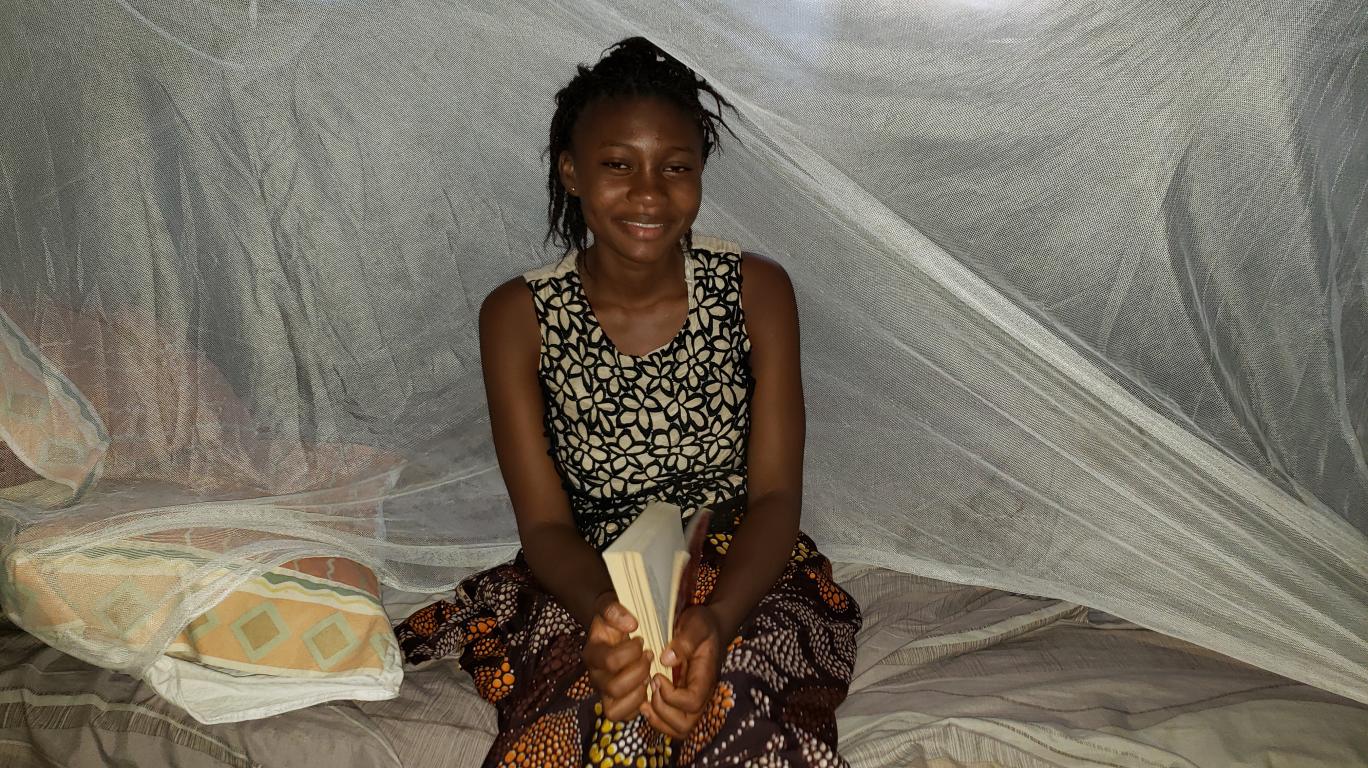 Haja studying under her bed net