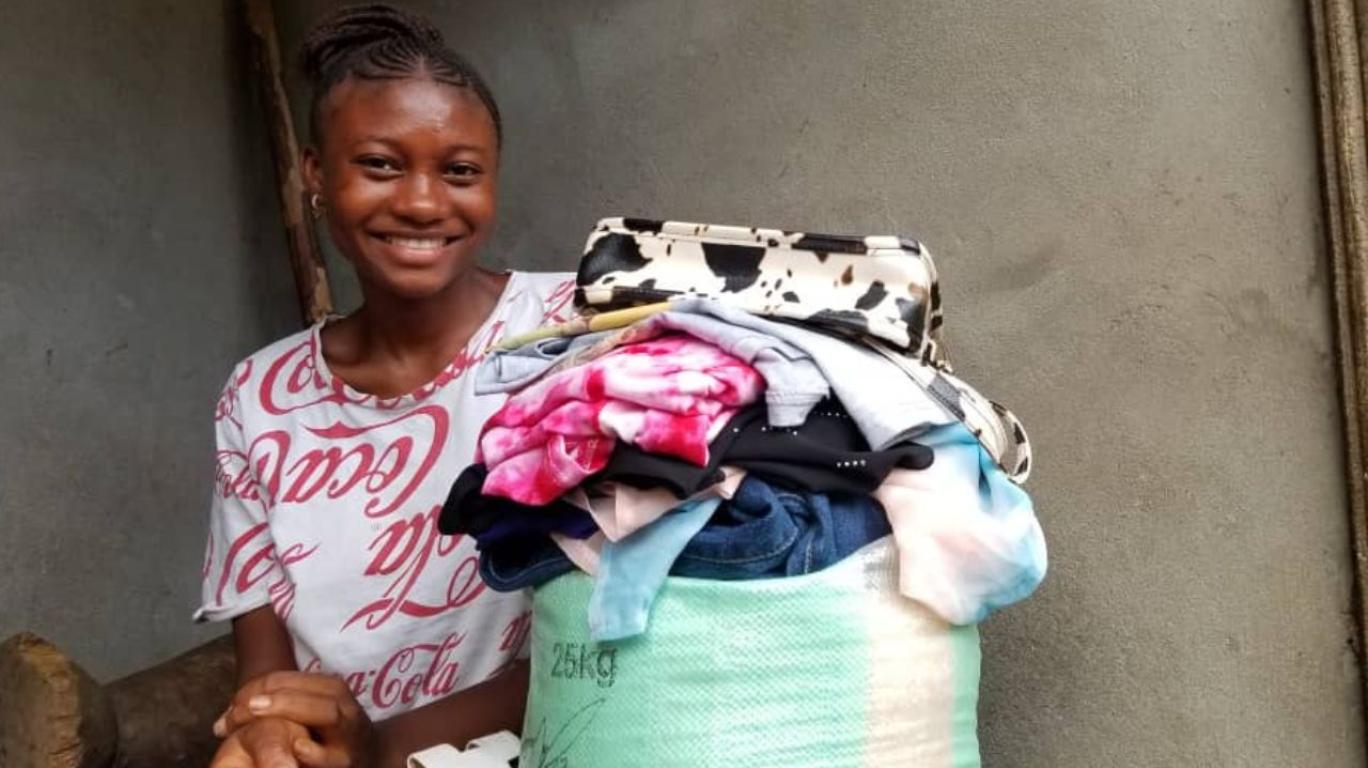 Haja with clothes and a bag of rice 