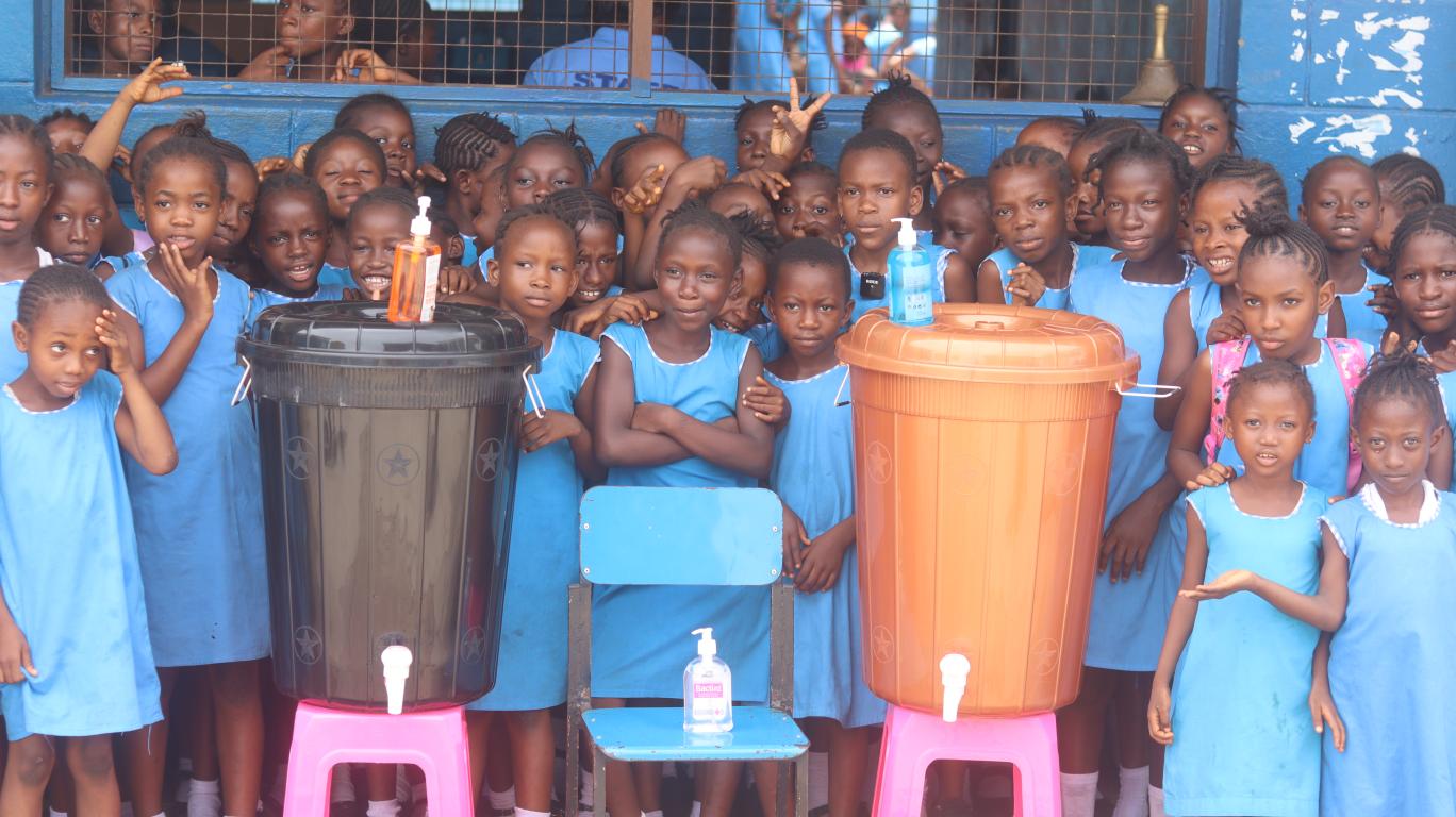 Fawe girls behind their two new handwashing stations