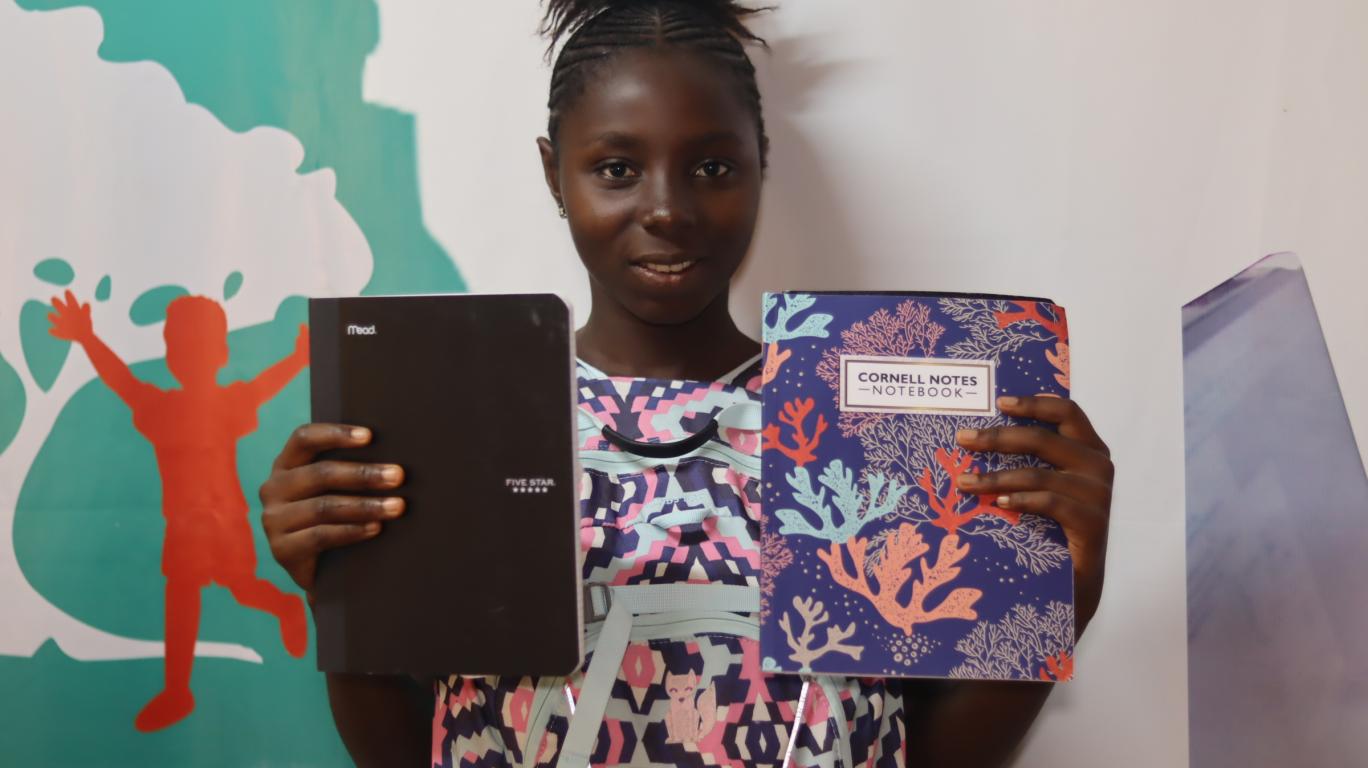 Isha with her new school supplies