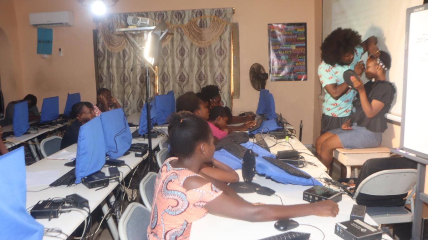 Teacher showing girls makeup techniques a mentoring session