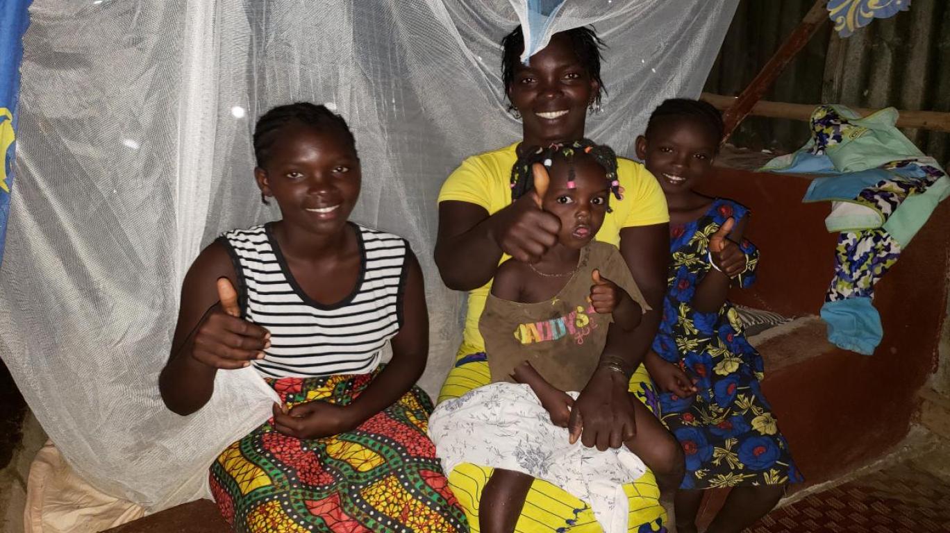 Sallay & her children under a bed net