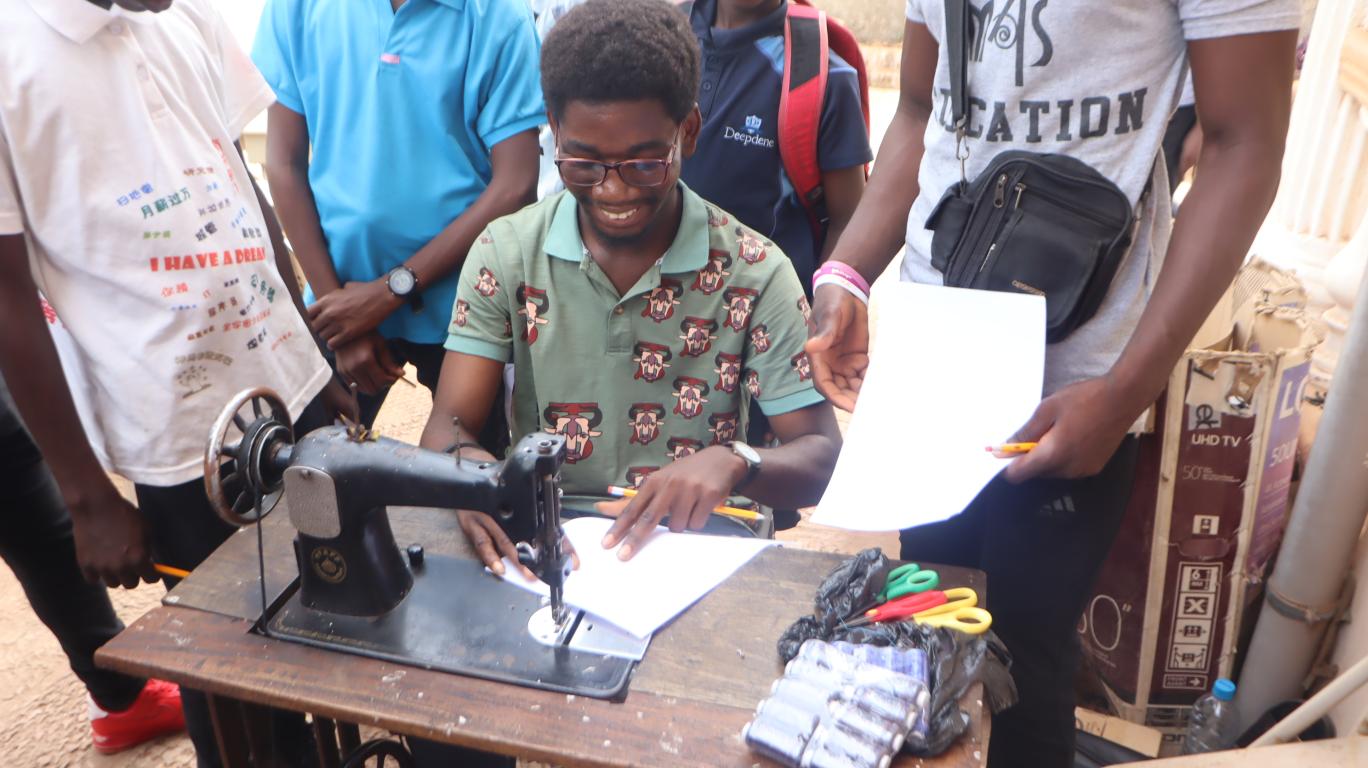 A Mentee Learning how to use a Sewing Machine
