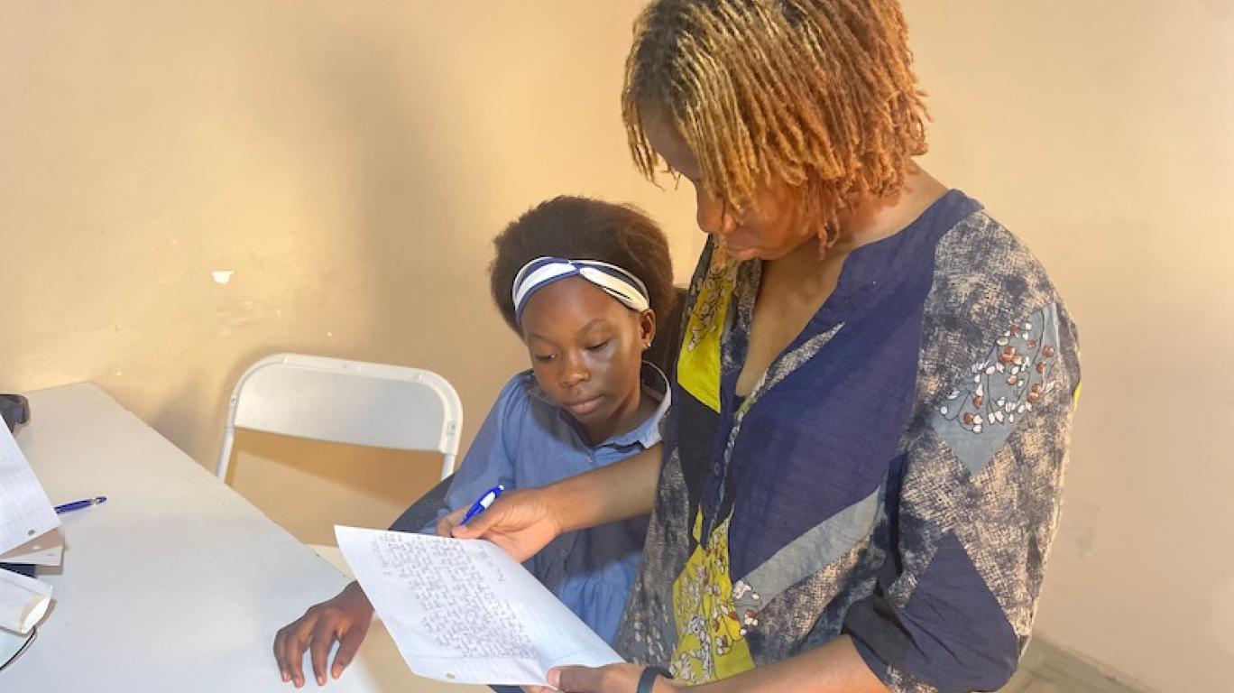 Aminata - Staff, reviewing Marina's letter to her sponsor, Develop Africa, 2026