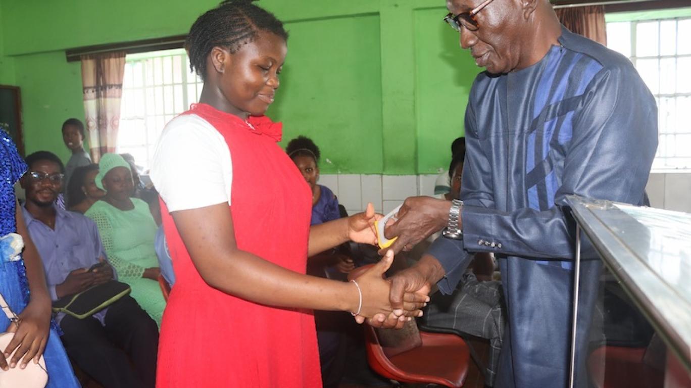 Girl receiving SolarBuddy lamp - Sierra Leone July, 2026