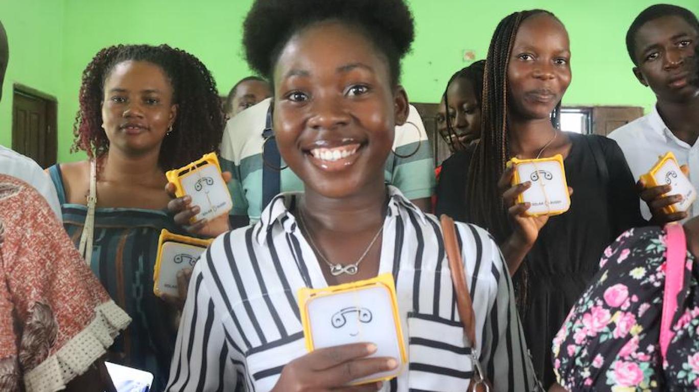 Kamara holding SolarBuddy lamp - Sierra Leone July, 2026