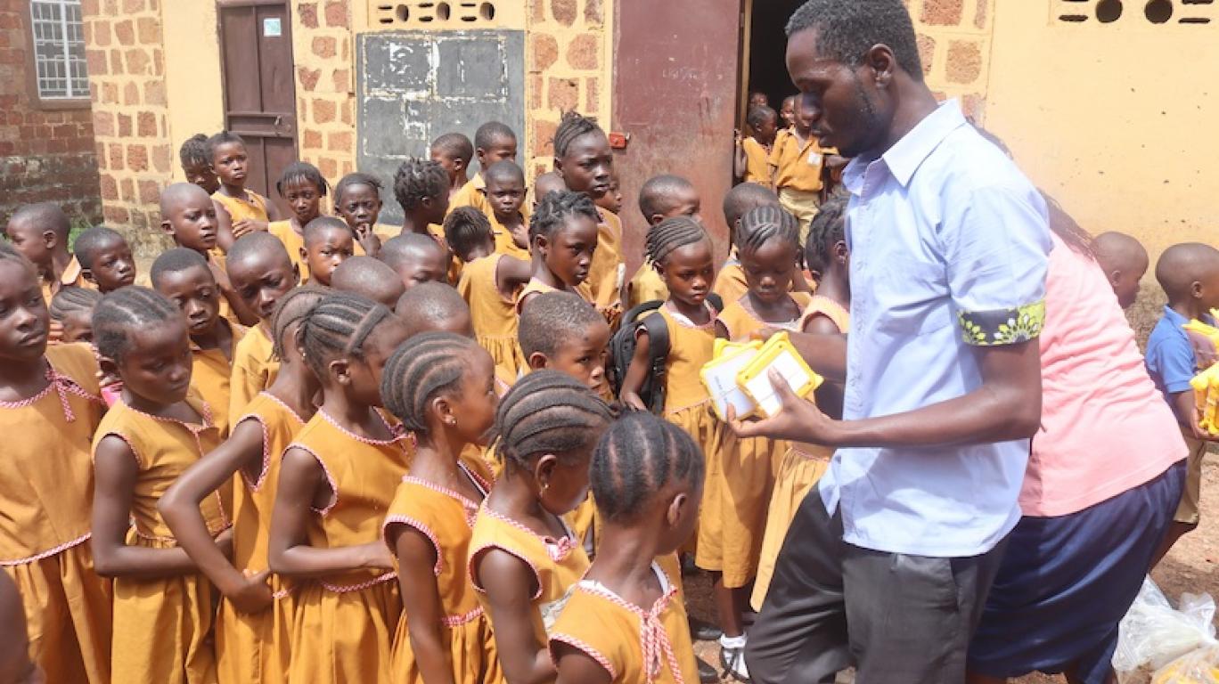 Staff distributing SolarBuddy lamps to kids - Sierra Leone - July 2026
