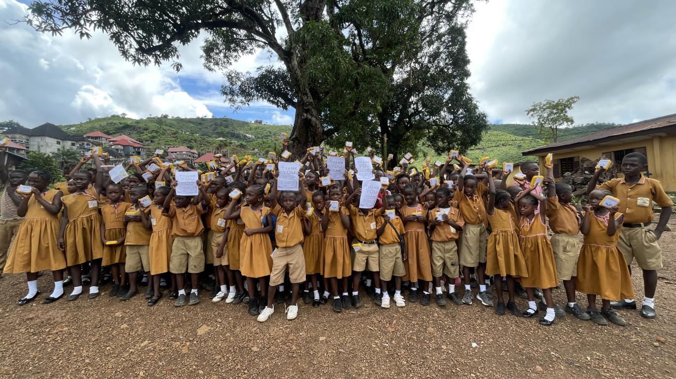 Students at REC Primary School Bathurst, Sierra Leone with SolarBuddy lamp