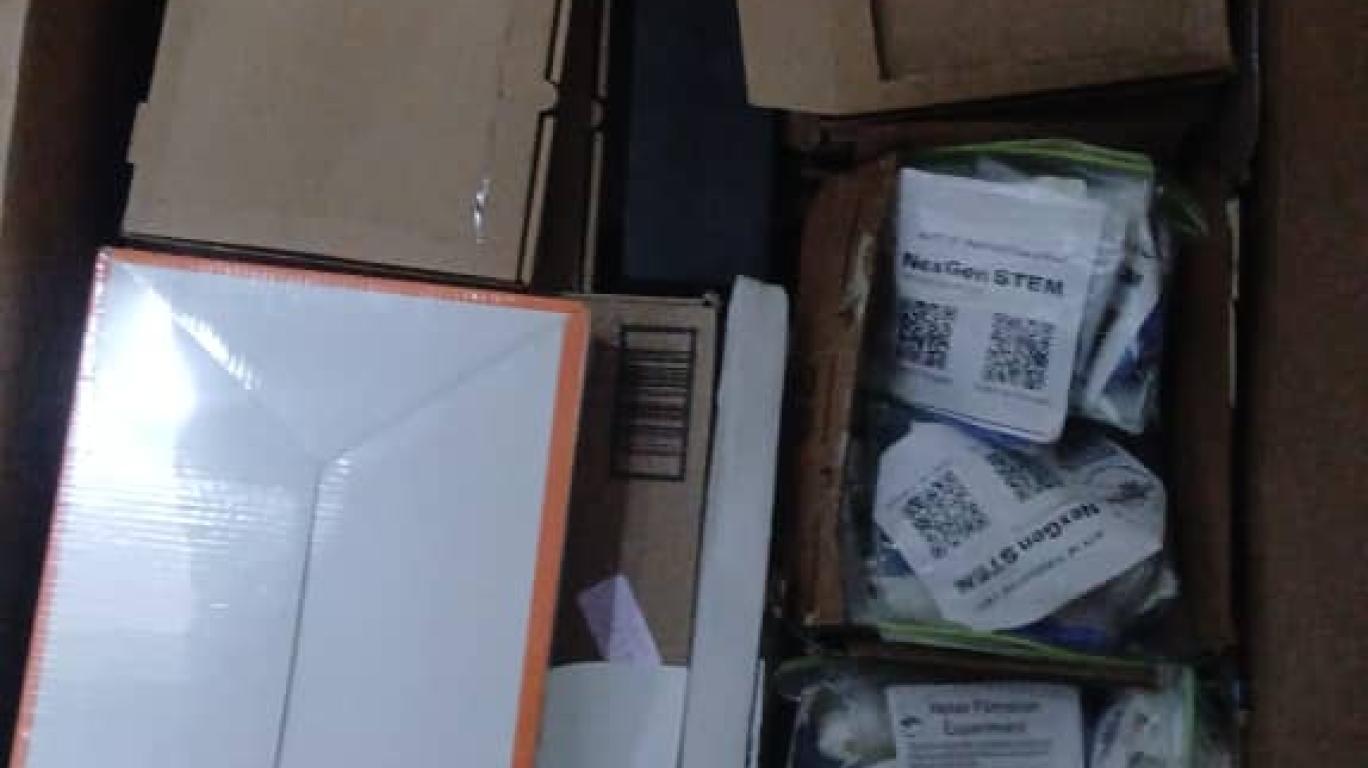 cartons of science kits donated by NEXGEN STEM