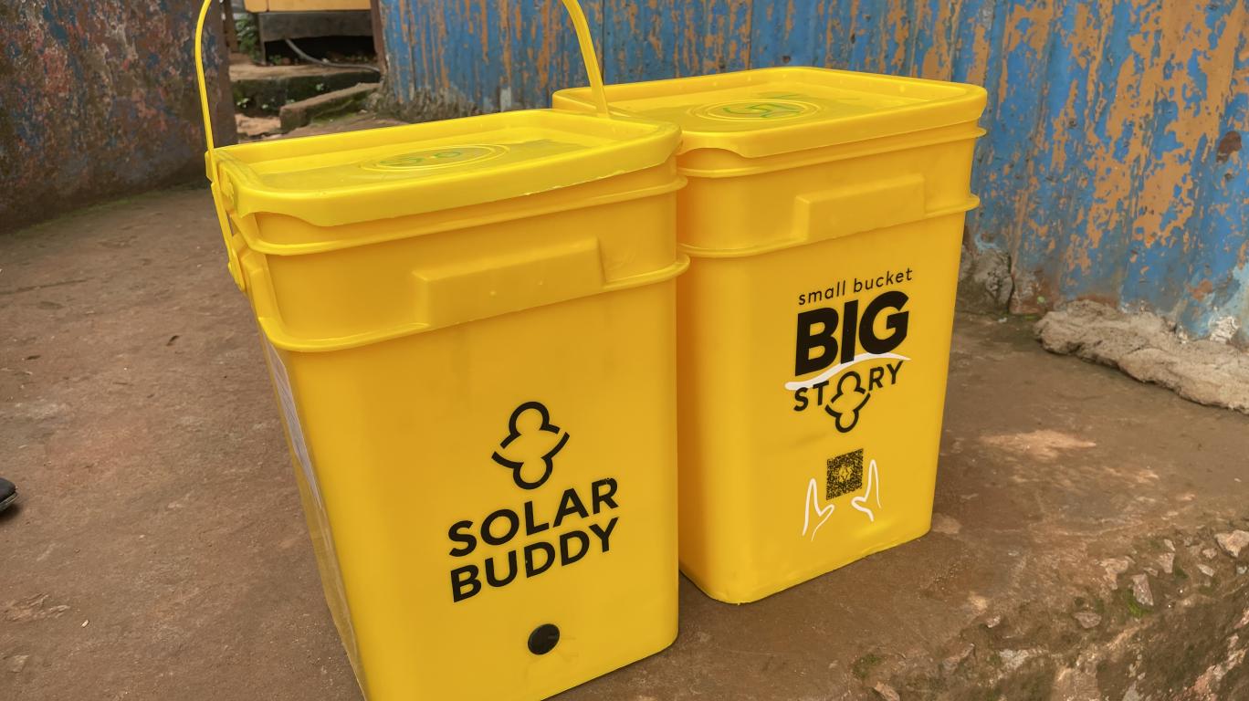 SolarBuddy bucket filled with SolarBuddy lamps