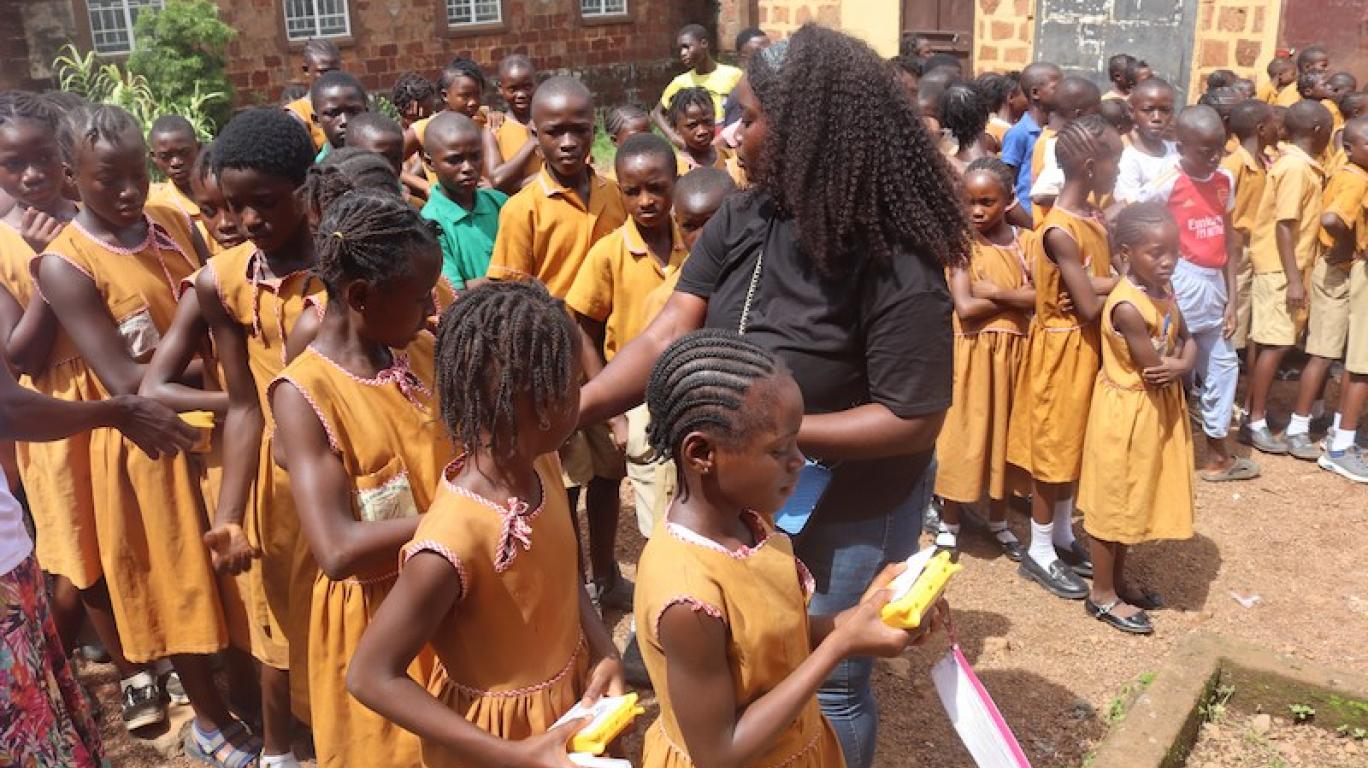 Staff distributing SolarBuddy lamps to kids - Sierra Leone - July 2026