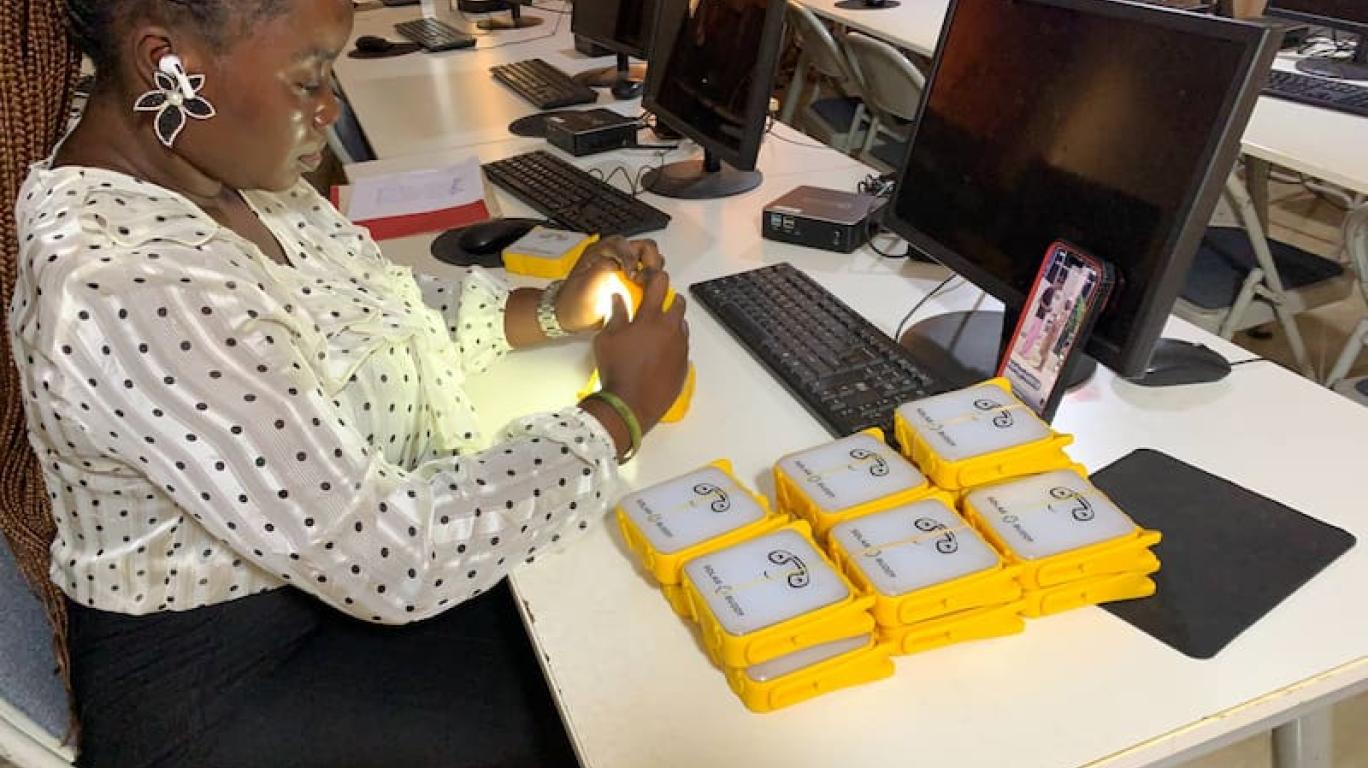 Staff packing SolarBuddy lamps - Develop Africa Sierra Leone, July 2026