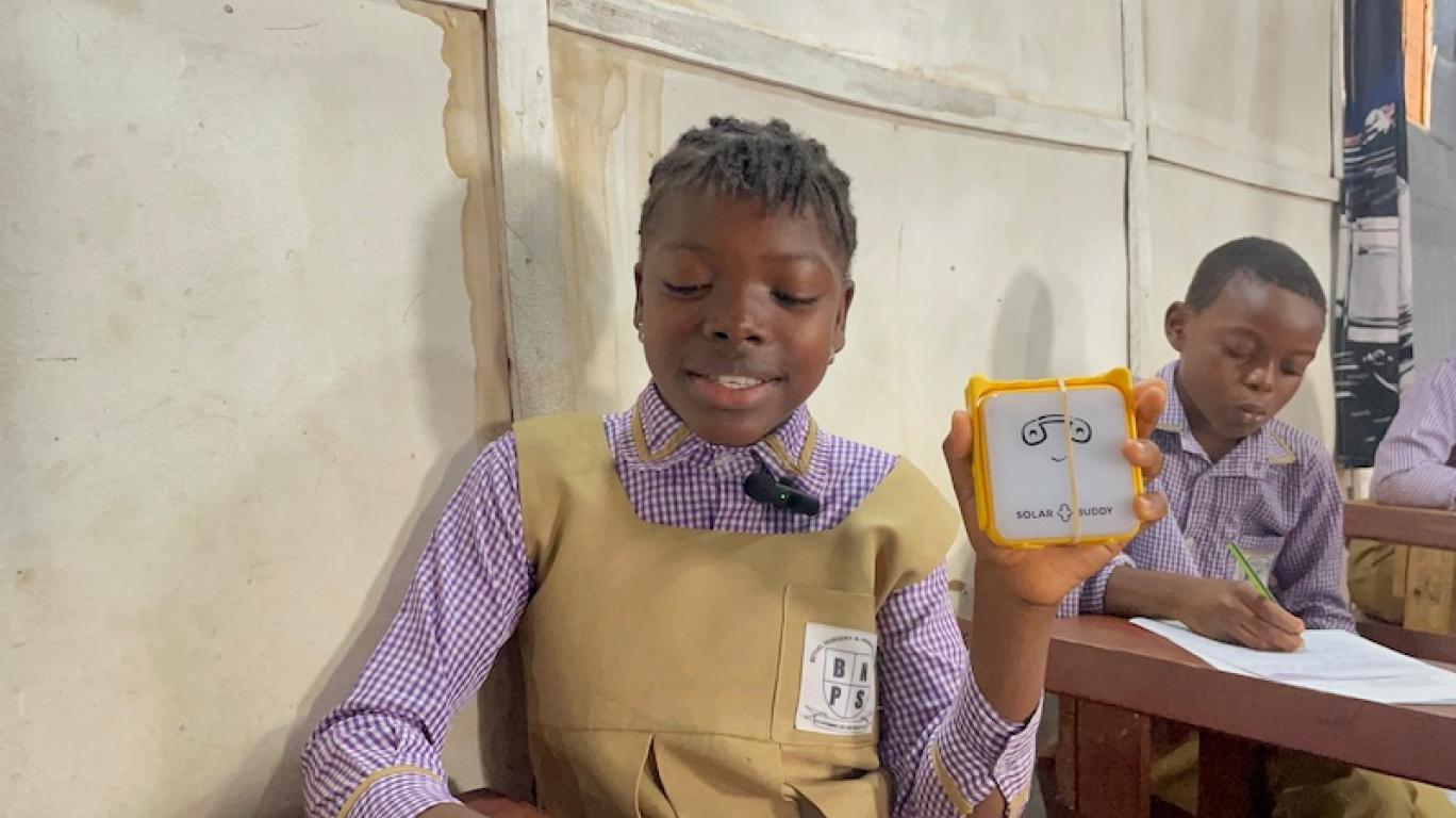 A student with SolarBuddy lamp - Sierra Leone, July 2026