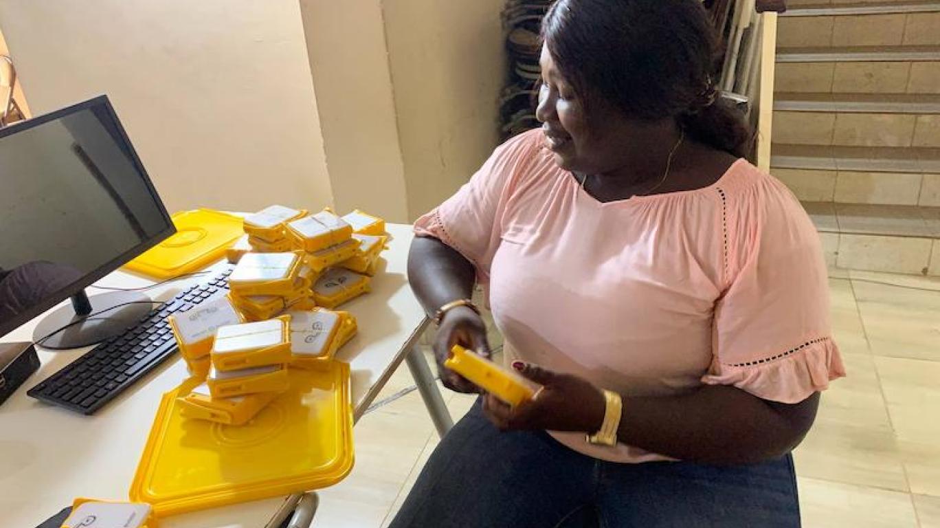 Thomascia, Beneficiary Packing Solar Buddy Lamps - Sierra Leone