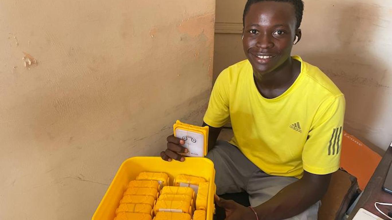 Volunteer Packing Solar Buddy Lamps In A Bucket - Sierra Leone