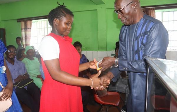 Girl receiving SolarBuddy lamp - Sierra Leone July, 2026