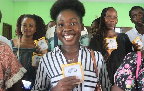 Kamara holding SolarBuddy lamp - Sierra Leone July, 2026
