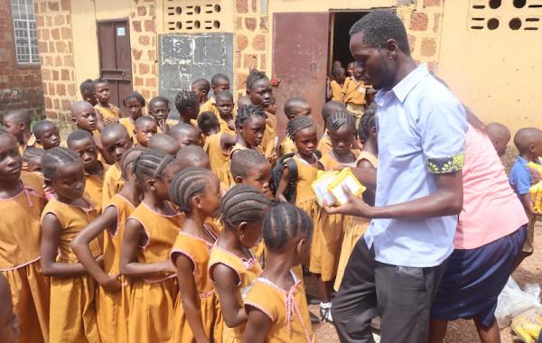 Staff distributing SolarBuddy lamps to kids - Sierra Leone - July 2026