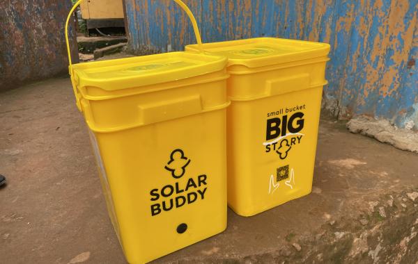 SolarBuddy bucket filled with SolarBuddy lamps