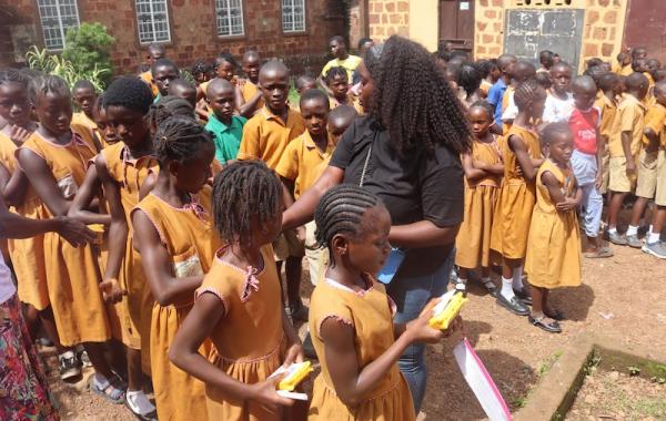 Staff distributing SolarBuddy lamps to kids - Sierra Leone - July 2026