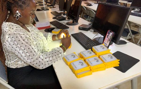 Staff packing SolarBuddy lamps - Develop Africa Sierra Leone, July 2026