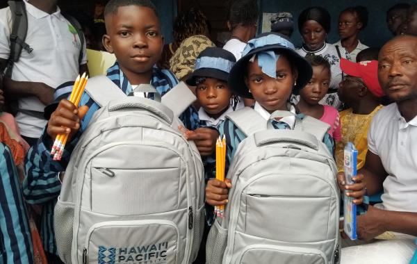 Young Students with bookbags and school supplies
