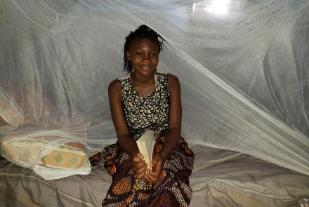 Haja studying under her bed net