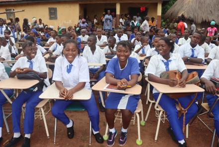 Students at newly donated desks 