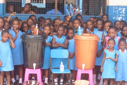 Fawe girls behind their two new handwashing stations