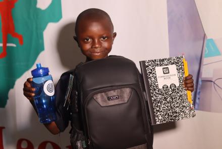 Boy with new school supplies