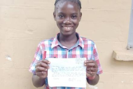 Jeneba with a letter to her sponsor
